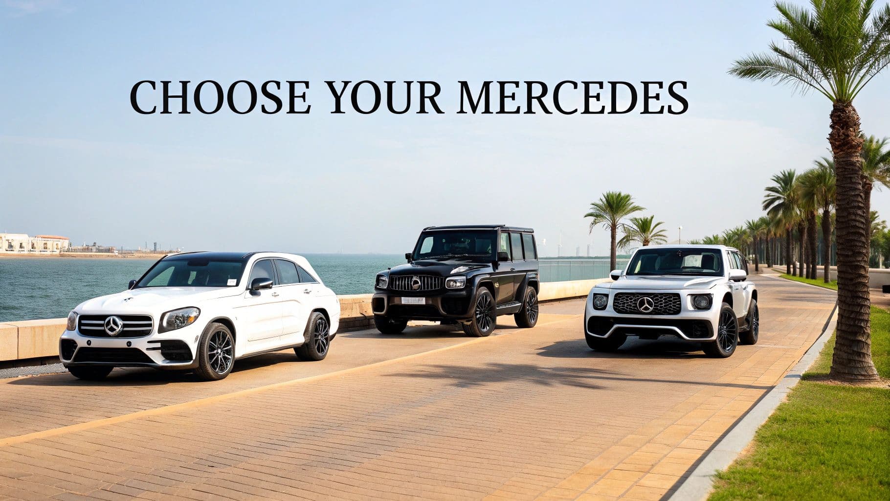 Three Mercedes-Benz SUVs, white, black, and silver, parked by the sea with palm trees.